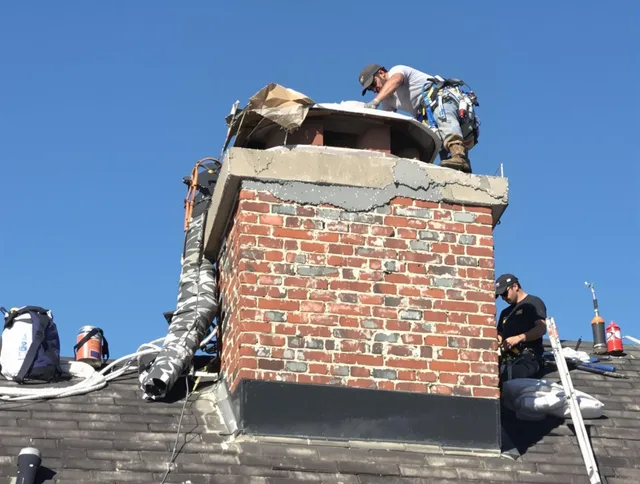 Westlake Chimney Sweep installing a custom chimney crown in Westlake, OH